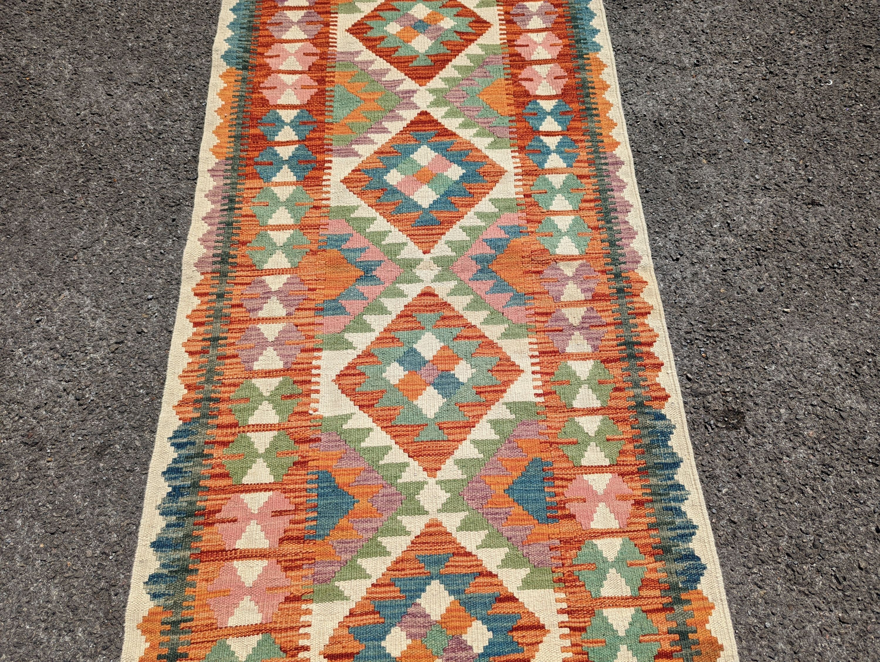 An Anatolian polychrome geometric flatweave Kilim runner, 290 x 84cm